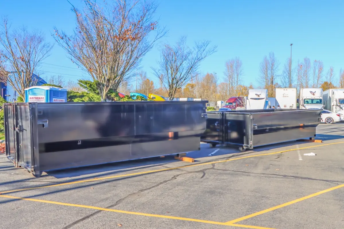 Professional dumpster rental service with roll-off container on residential driveway in Edgewater Park